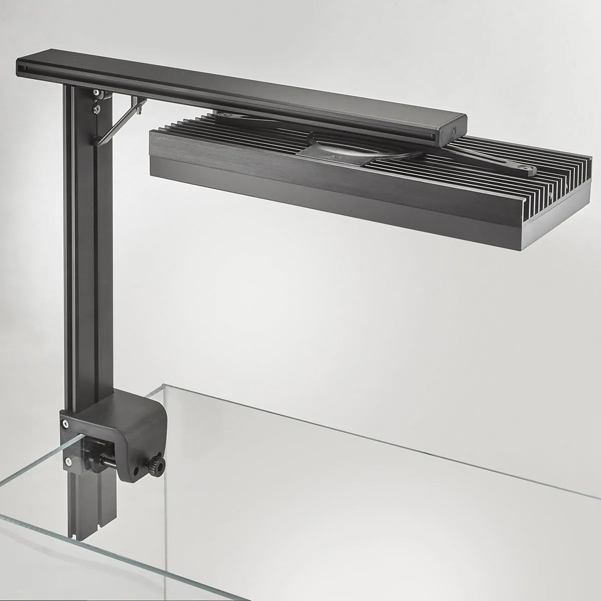 Black metal bracket on a glass surface with a white background