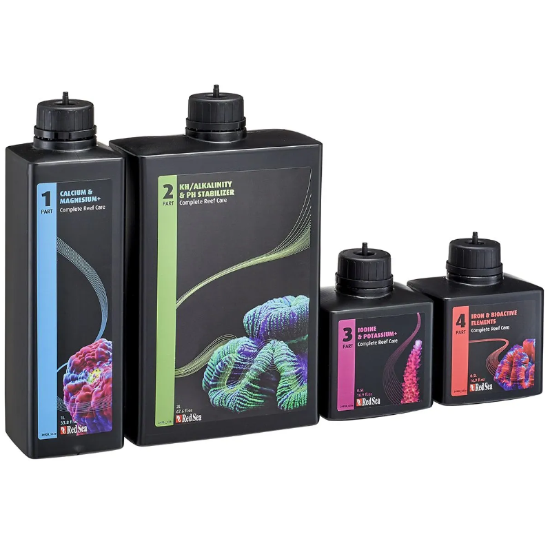 Set of four black bottles with colorful labels on a white background