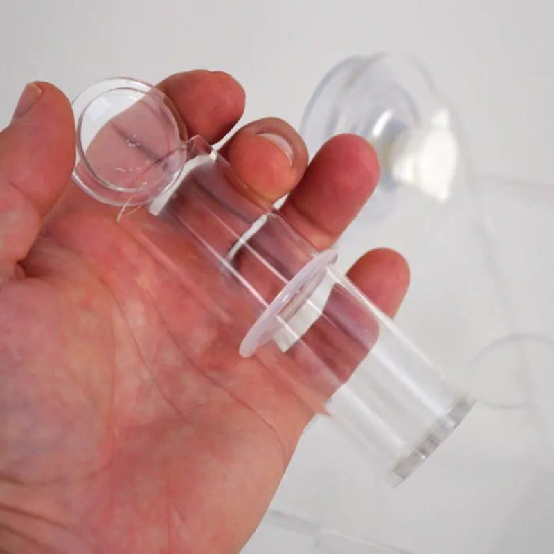 Clear plastic ring held in a hand against a white background