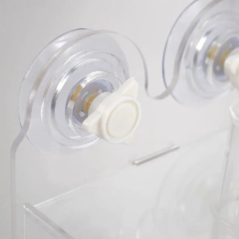 Close-up of a clear plastic product with a white component on a light gray background