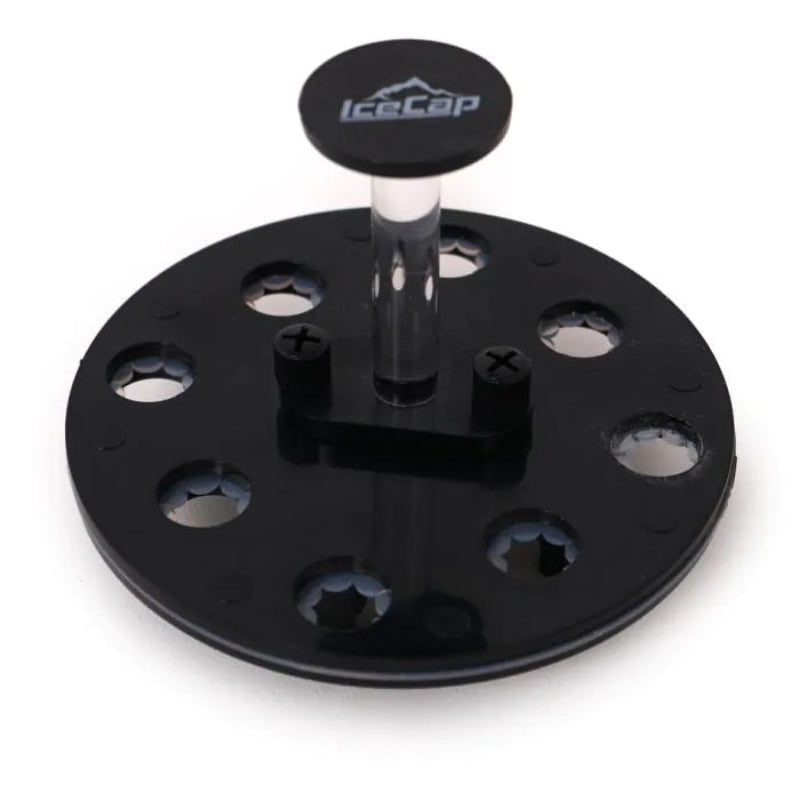 Black metal plate with multiple holes and a central cylindrical component on a white background, featuring the IceCap logo.