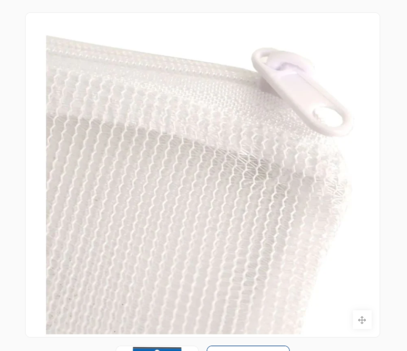 White mesh laundry bag with a button on a white background