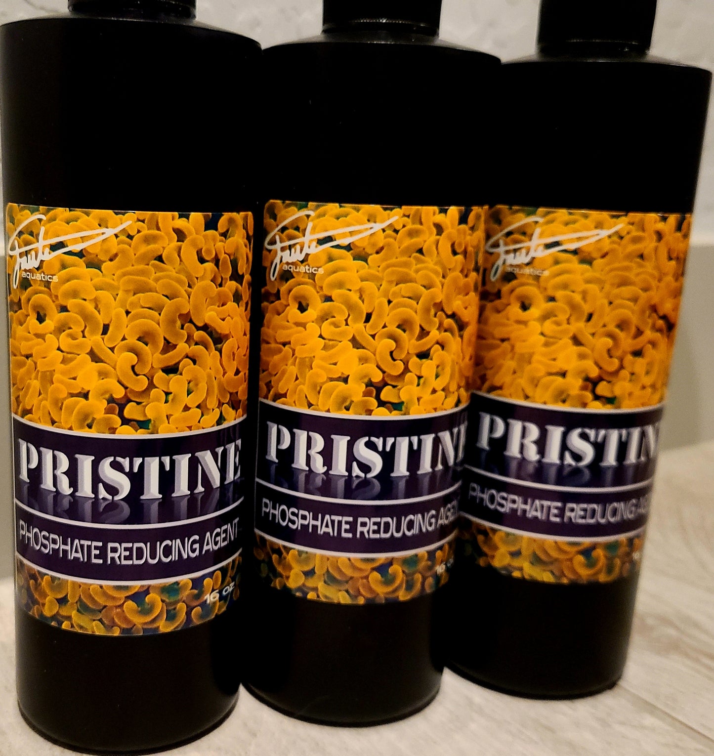Three bottles of PRISTINE Phosphate Reducing Agent by Fauth Aquatics, each containing 16 oz of liquid.