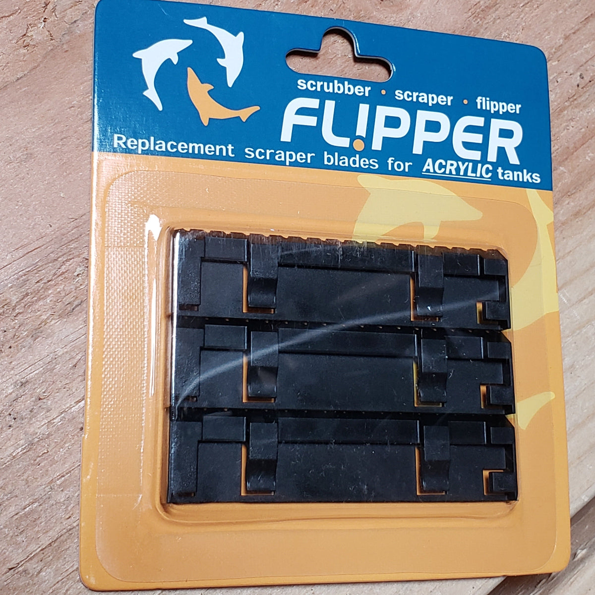 Packaging of Flipper brand replacement acrylic scraper blades for an aquarium cleaning tool, featuring the product visible through a clear plastic window.