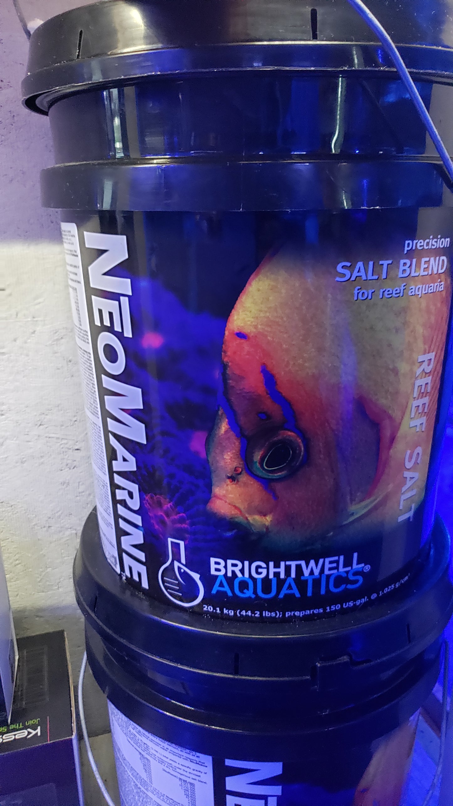 A black bucket labeled with 'NeoMarine Salt 150 gal' from Brightwell Aquatics, intended for use in saltwater aquariums.