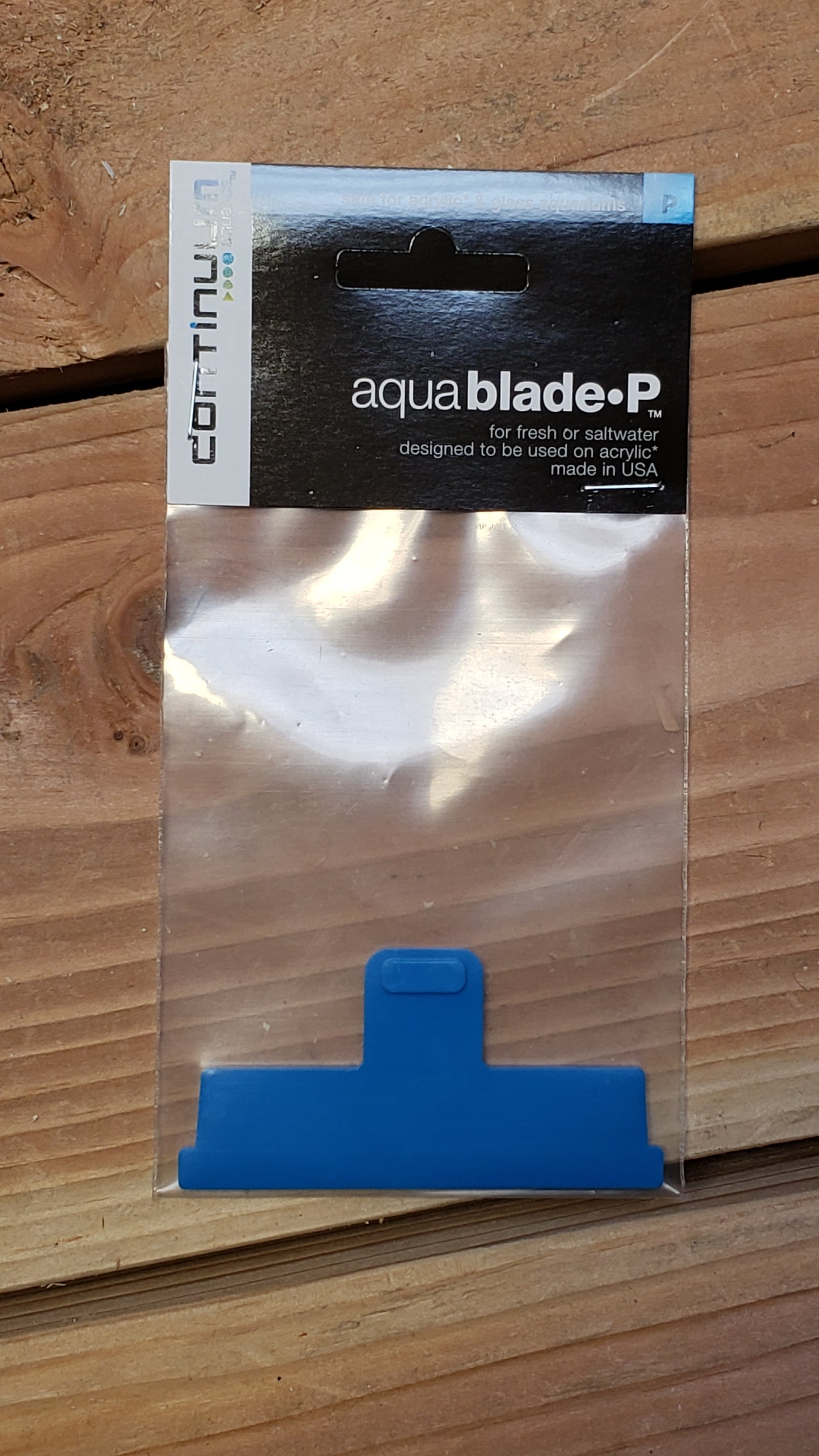 A blue acrylic blade for an aquarium filtration system, packaged in a clear plastic bag with a label reading 'AquaBlade P' and the brand name 'Brightwell'.