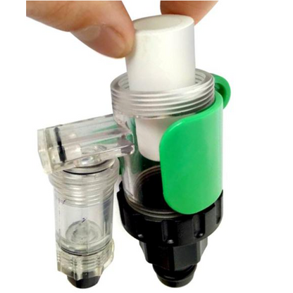Plumbing fitting with a green handle held by a hand on a white background