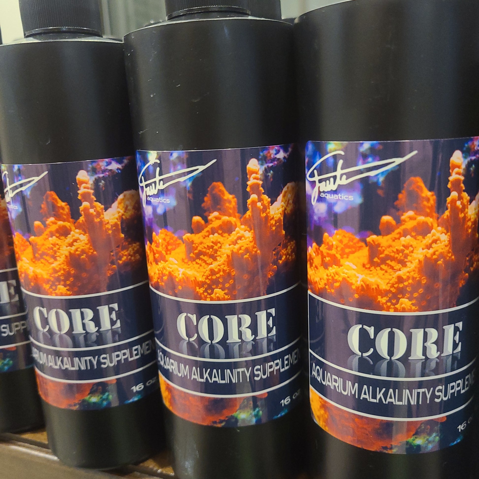 Bottles of CORE Alkalinity by Fauth Aquatics, a aquarium water treatment product, with branding and an image of coral on the label.